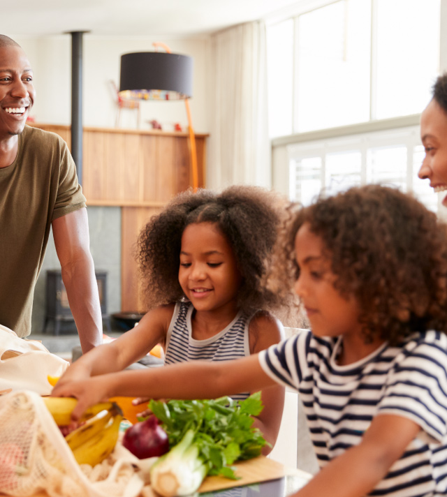 Happy family unpacking their groceries